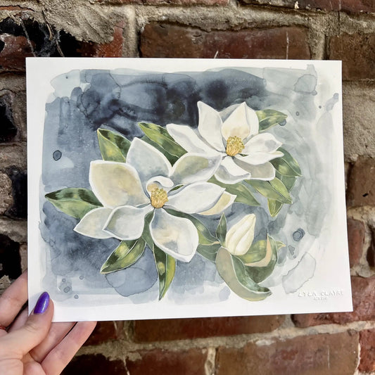 Southern Magnolia Print by Lyla Clayre Studio — watercolor magnolias on blue-gray background on Tampa Home & Garden Store