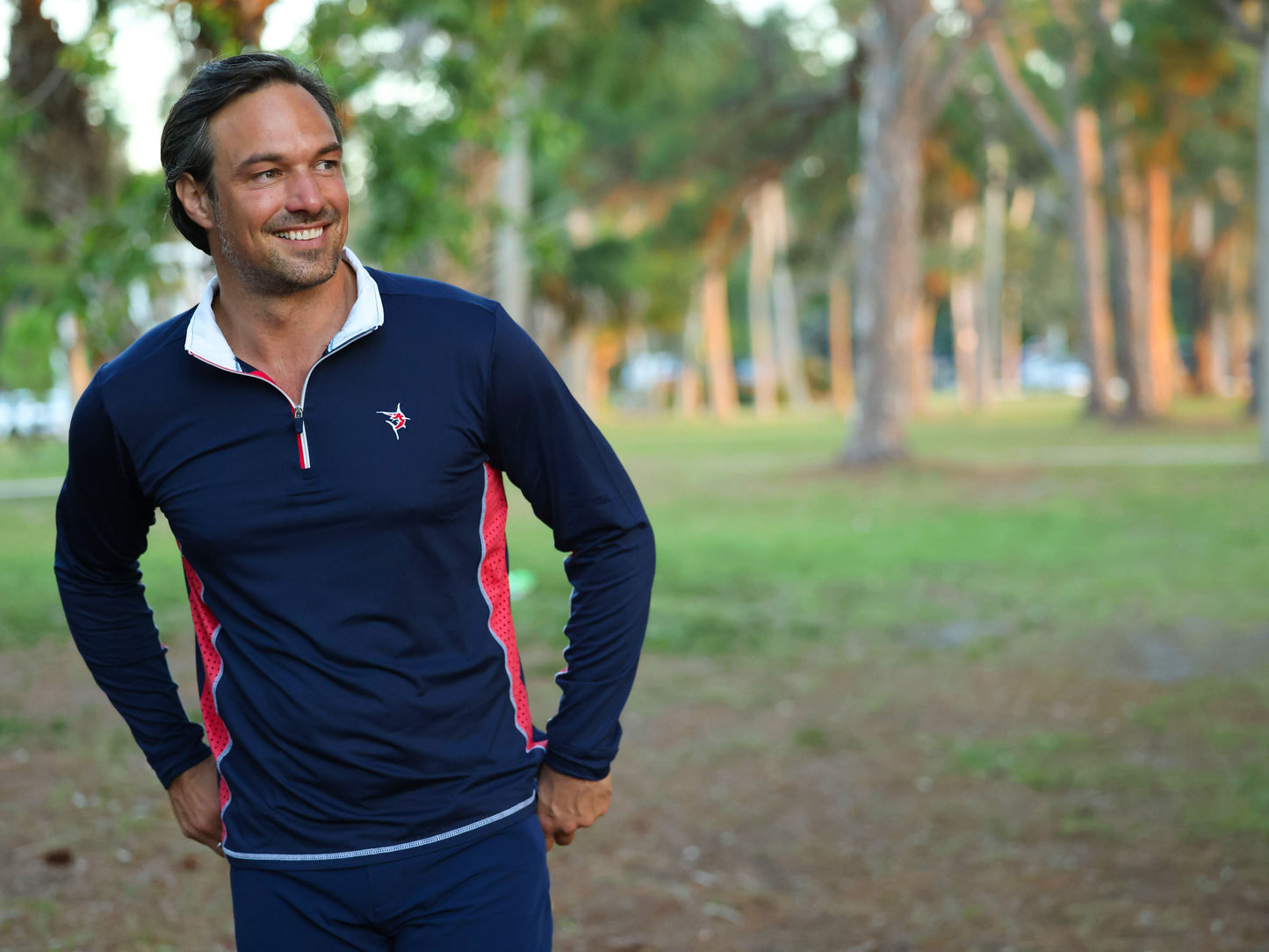 Southport athletic shirt navy with red panels by White Water Life worn by man in park on Tampa Home & Garden Store