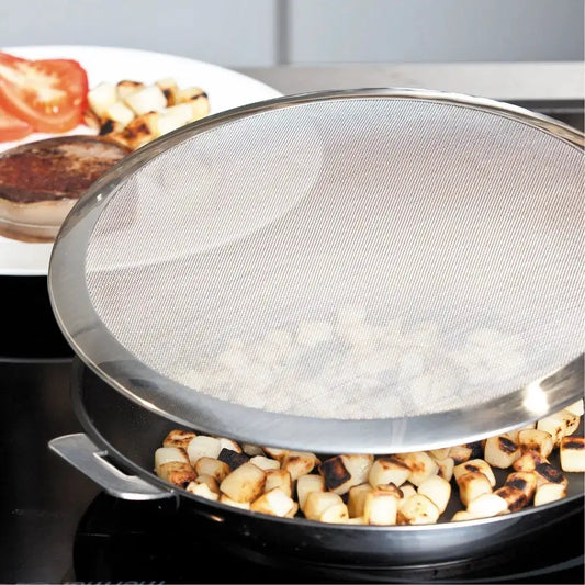 Stainless steel splatter screen with detachable handle over saute pan with diced potatoes on Tampa Home & Garden Store