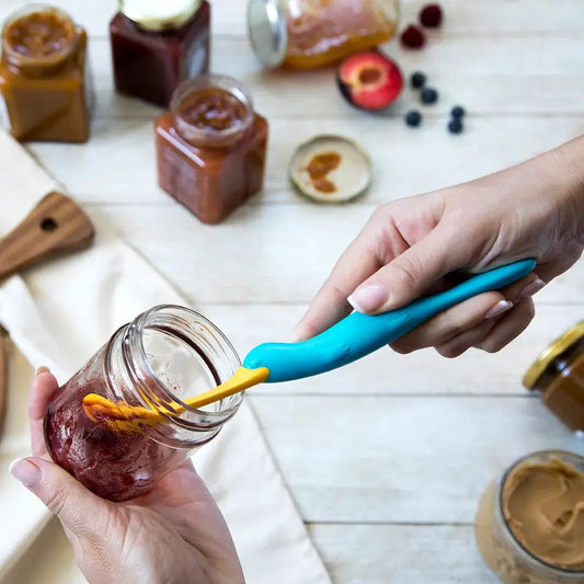 Splatypus jar scraper by OTOTO turquoise handle with yellow tip scraping jam from jar on Tampa Home & Garden Store