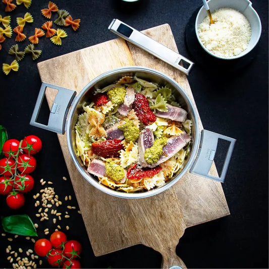 Stainless steel stewpan with glass lid, CRISTEL USA, gray handles, pasta dish inside on Tampa Home & Garden Store