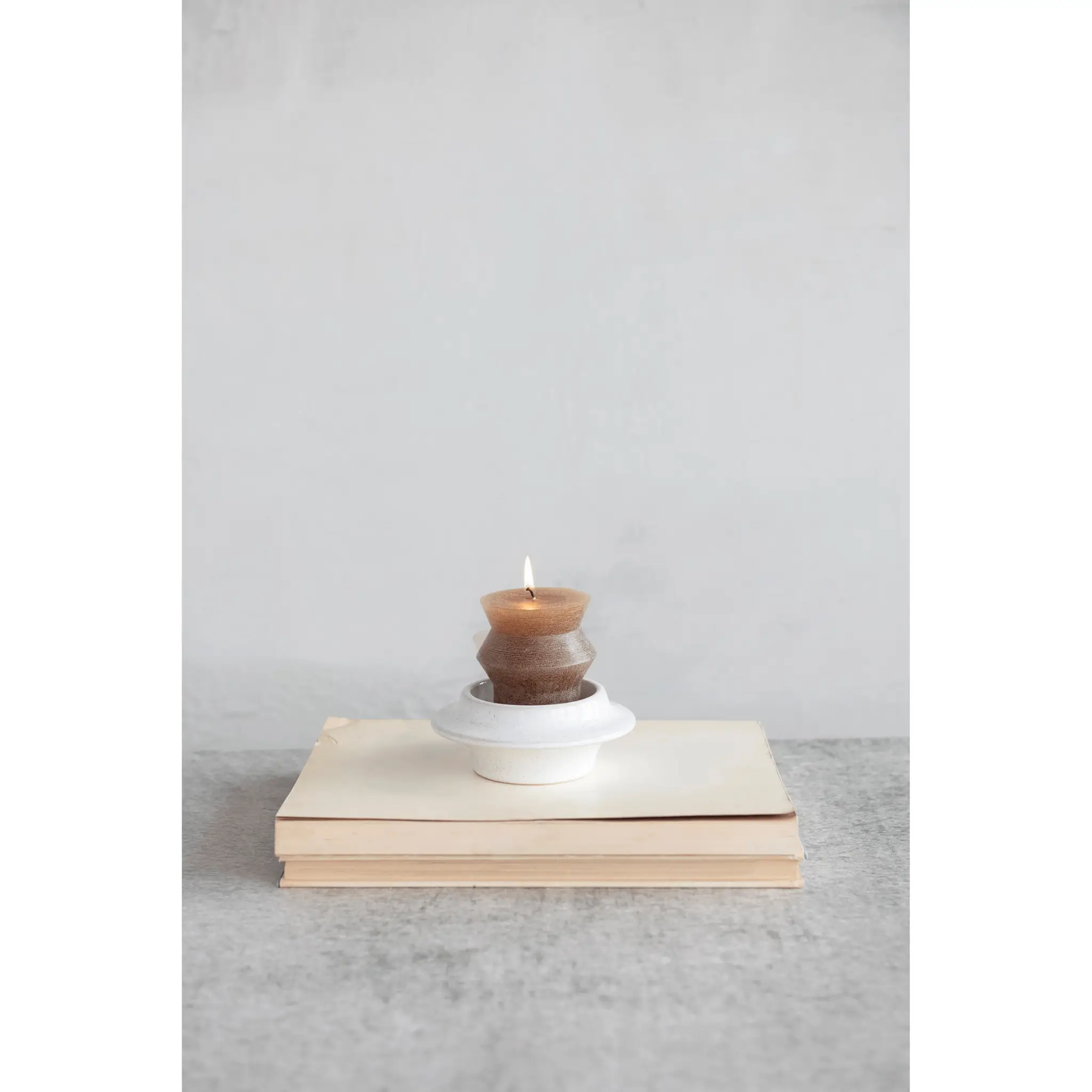 Stoneware Tea Light and Pillar Candle Holder with stacked brown ceramic rings and lit tea light on Tampa Home & Garden Store