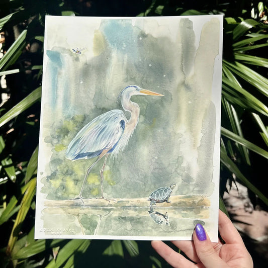 Swamp Friends paper prints by Lyla Clayre Studio featuring watercolor blue heron and turtle in a swamp scene on Tampa Home & Garden Store
