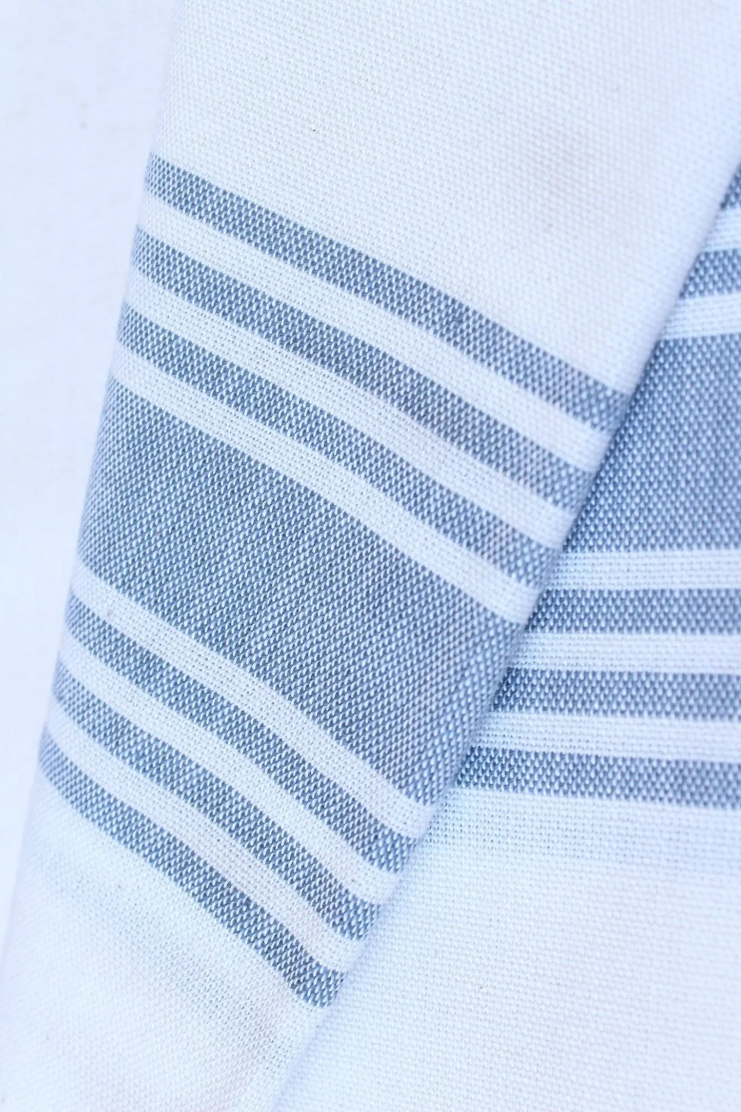 Symi White and Denim Turkish Towel with blue striped edge, textured weave close-up on Tampa Home & Garden Store