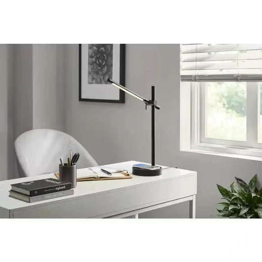 Black LED desk lamp with wireless charging pad and adjustable arm on white desk on Tampa Home & Garden Store