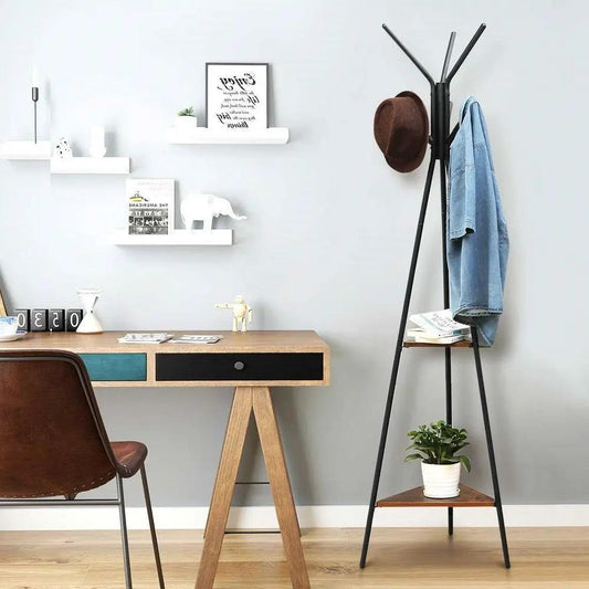Modern coat rack with matte-black metal frame and tripod legs, holding a hat and denim jacket on Tampa Home & Garden Store