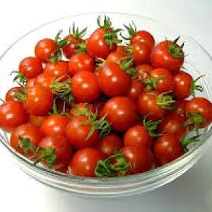 Heirloom red cherry tomatoes in a glass bowl with green calyxes on Tampa Home & Garden Store