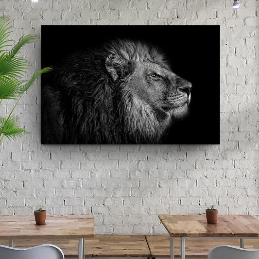 Black and white lion head canvas wall art with gray fur and orange eye on black backdrop on Tampa Home & Garden Store