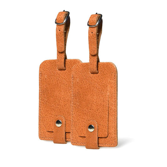 Tan buffalo leather luggage tag set of two with metal buckles on Tampa Home & Garden Store