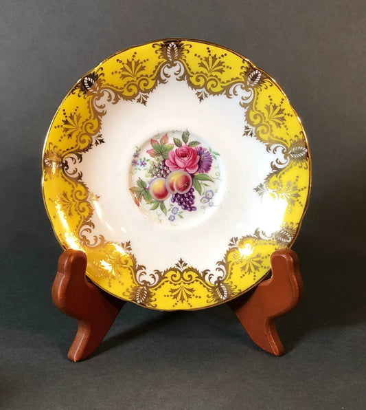 Paragon tea cup and saucer with yellow gilt border and gold scrollwork, pink floral center on Tampa Home & Garden Store