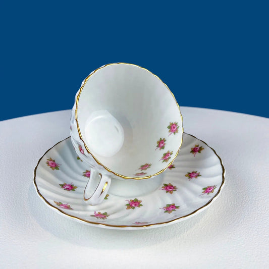 Tea cup and saucer set in white china with pink rose pattern and gold trim on Tampa Home & Garden Store