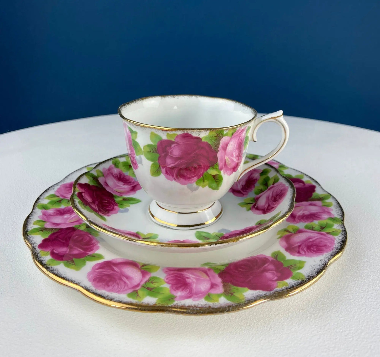 Teacup and saucer set with pink rose pattern and gold rim on white porcelain on Tampa Home & Garden Store