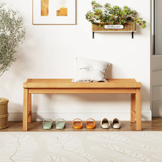 Teak wood backless bench with contoured seat, natural finish; four pairs of sandals beneath on Tampa Home & Garden Store