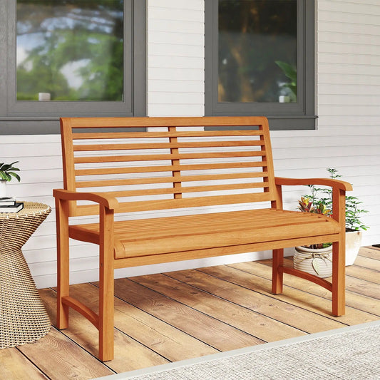 Teak wood outdoor garden bench with slatted back and seat on a wooden deck on Tampa Home & Garden Store