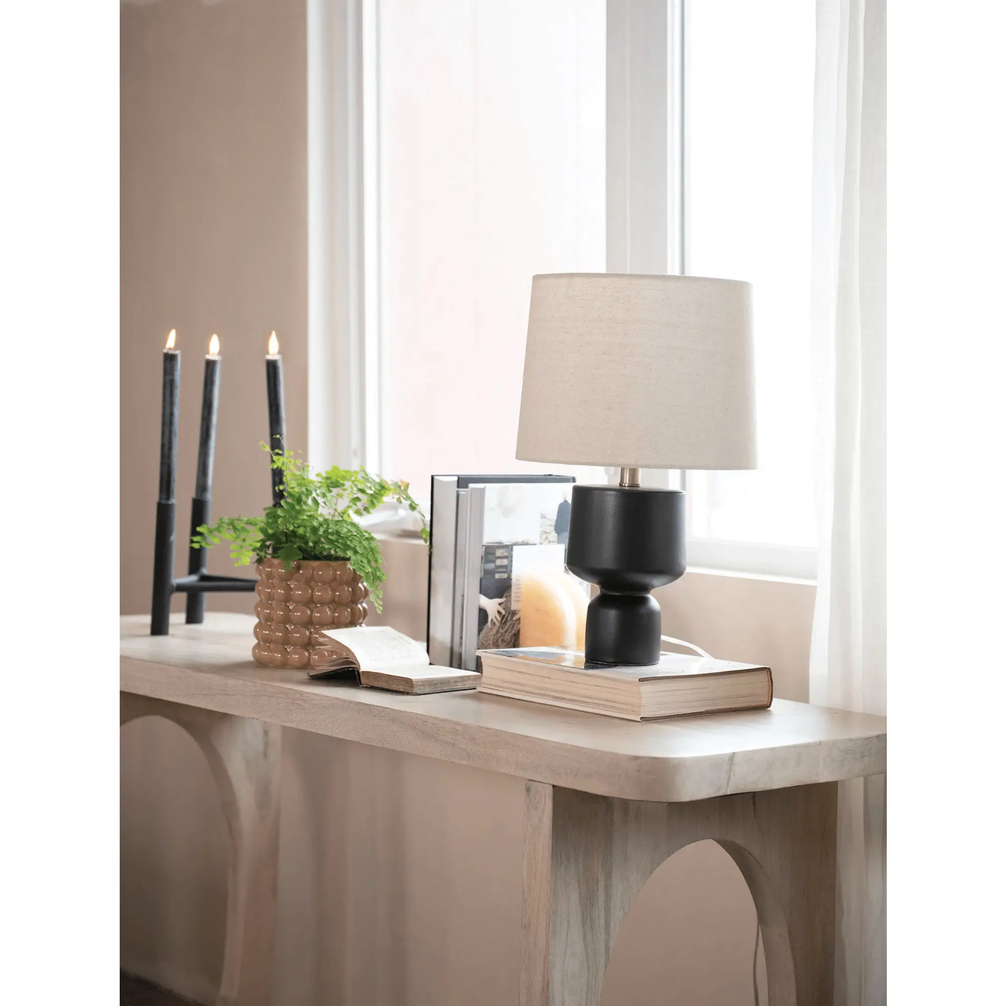 Textured Metal Triple Taper Candle Holder Black with three taper candles on a wood console on Tampa Home & Garden Store