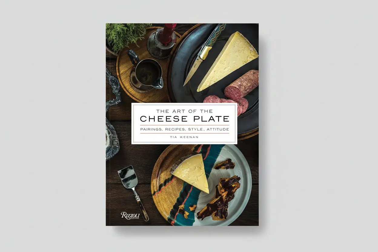 Cookbook The Art of the Cheese Plate cover with cheese wedges on a dark board and Rizzoli logo on Tampa Home & Garden Store
