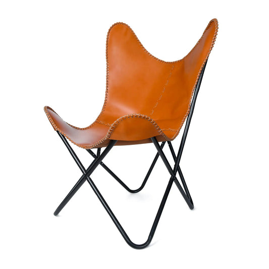 Vintage tan leather butterfly chair with stitched edges and black metal frame on Tampa Home & Garden Store