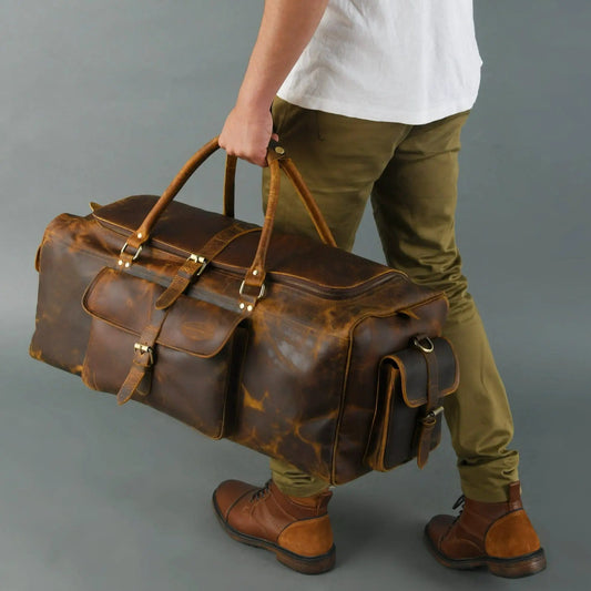 Goldman Hemingway Travel Duffel in distressed brown leather with top handles and buckles on Tampa Home & Garden Store