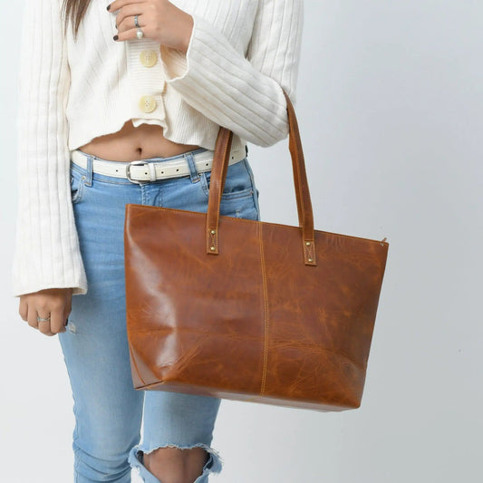 Kim Tote Bag Cocoa Brown leather handbag with tan handles carried by woman in sweater on Tampa Home & Garden Store
