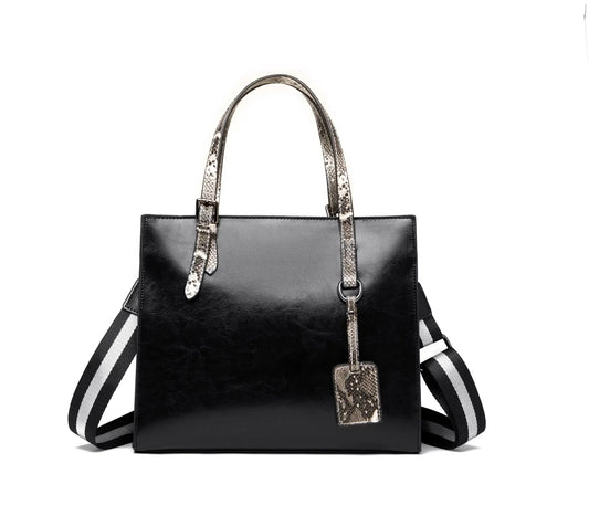 Medium Crossbody Tote leather handbag with black body and snake-print handles on Tampa Home & Garden Store