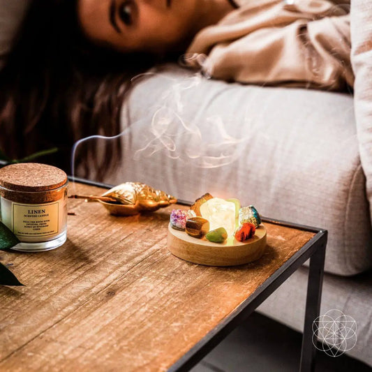 Natural Energy Lamp night light with crystal stones on a wooden tray beside linen candle Conscious Items logo on Tampa Home & Garden Store