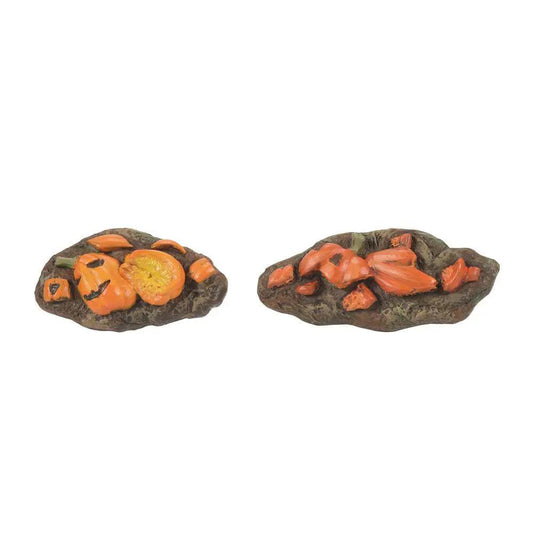 Smashed Pumpkins of November First two crushed orange pumpkins on dark rocky bases on Tampa Home & Garden Store
