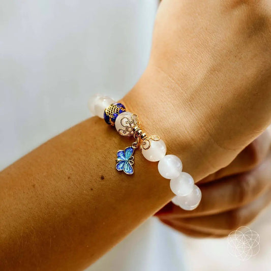 Spiritual Growth Bracelet with white beads, blue butterfly charm, and gold filigree accents on Tampa Home & Garden Store