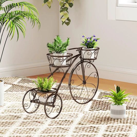 Tricycle plant stand in bronze metal with 3 hollow baskets holding white pots and green plants on Tampa Home & Garden Store