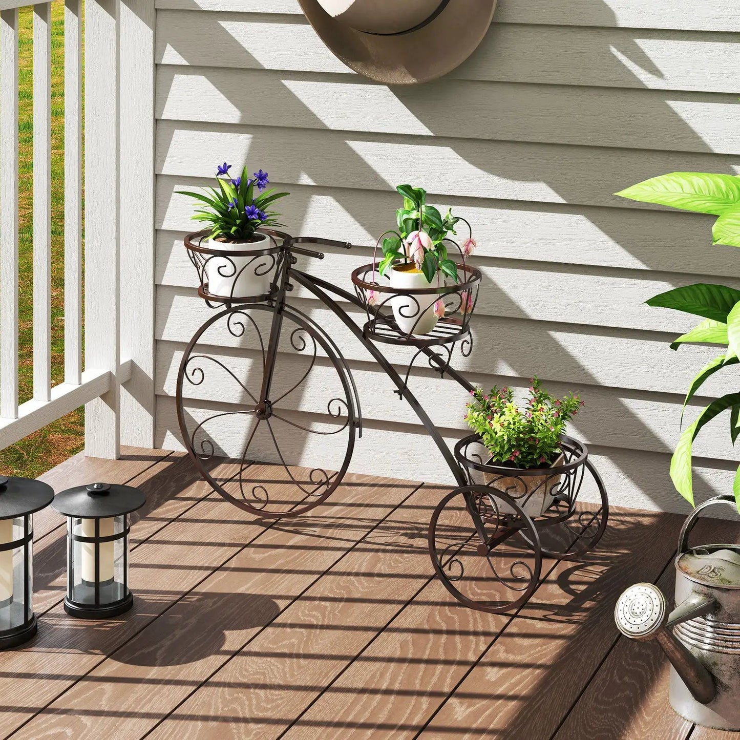 Tricycle plant stand with 3 hollow bronze baskets holding potted plants on porch on Tampa Home & Garden Store