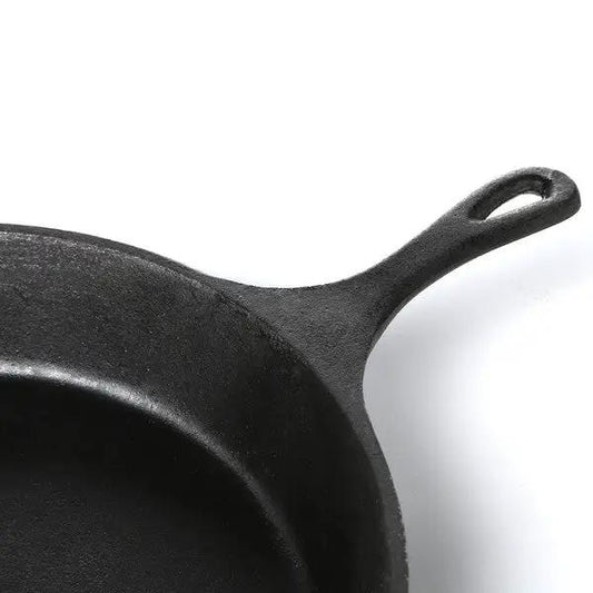Pre-seasoned cast iron 14-inch round skillet with black finish and loop handle close-up on Tampa Home & Garden Store