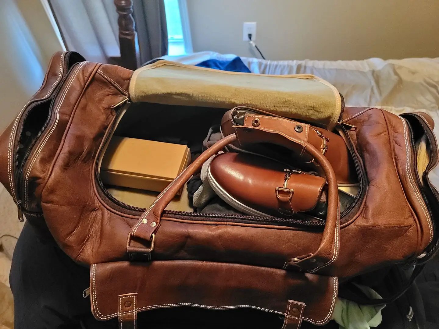 Goat leather weekender duffel bag, brown with white stitching, open to reveal pockets on Tampa Home & Garden Store