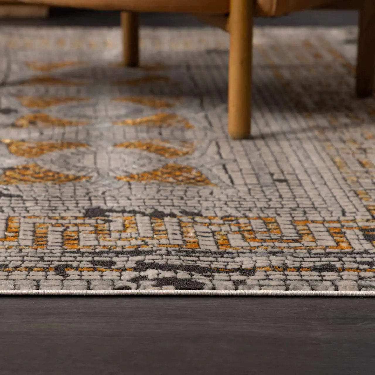 Mustard mosaic-texture area rug by Boutique Rugs under wooden chair legs on Tampa Home & Garden Store