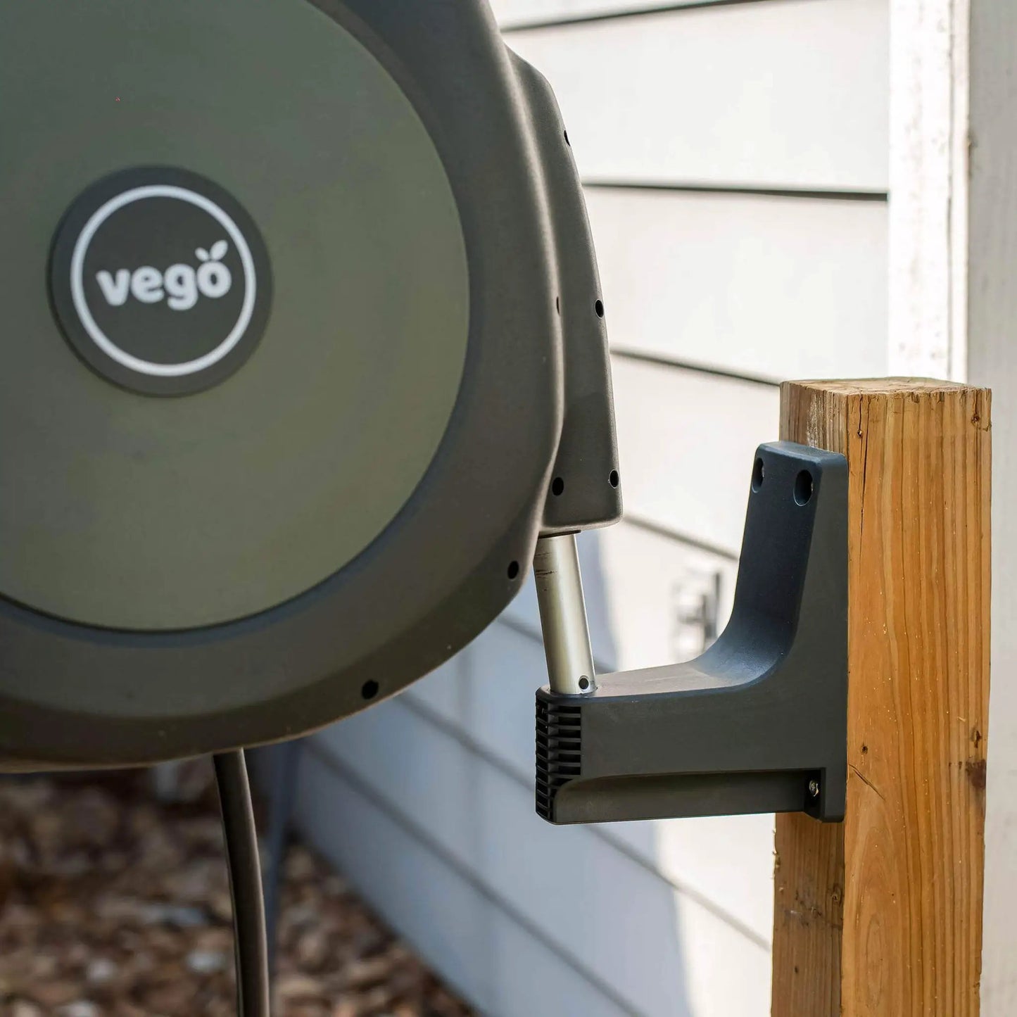 Vego Retractable Hose Reel Set olive green housing mounted on wall with bracket on Tampa Home & Garden Store