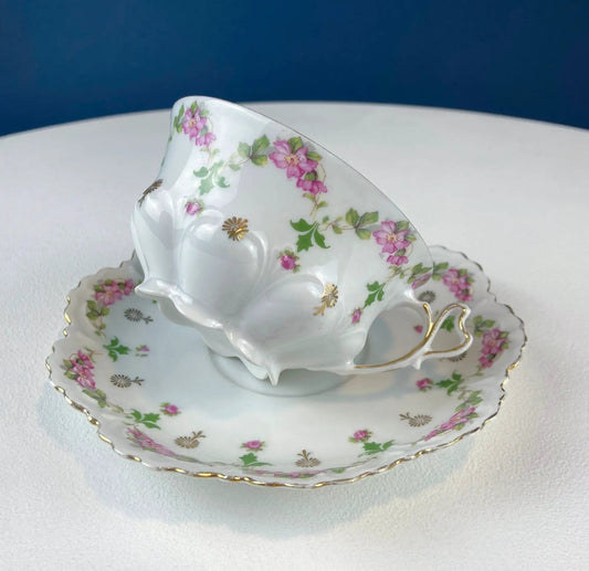 Very lightweight porcelain teacup and saucer with pink floral pattern and gold trim on Tampa Home & Garden Store