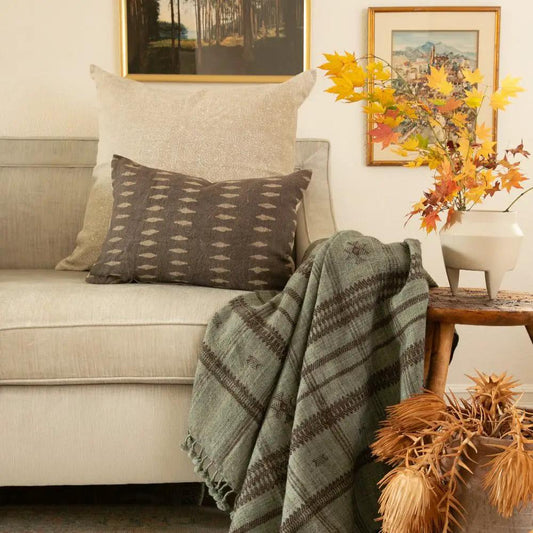 Vina Linen Block Print Throw Pillow Cover Sand on beige sofa with plaid blanket and fall vase on Tampa Home & Garden Store