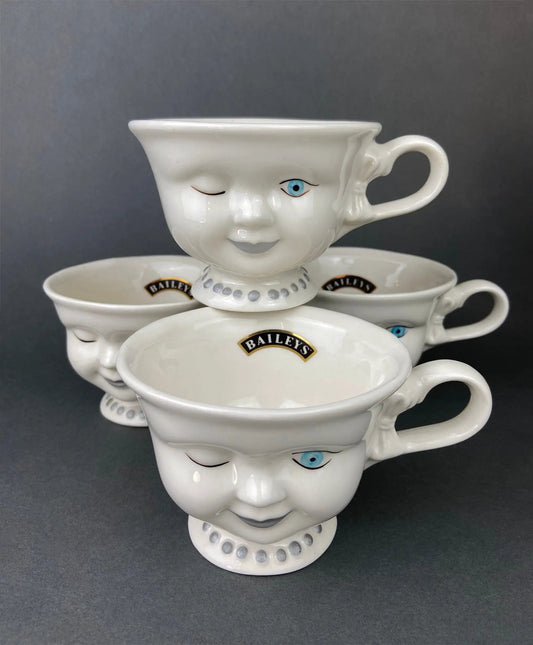 Baileys Irish Cream winking-face cups, set of five, white ceramic with blue-eyed faces on Tampa Home & Garden Store