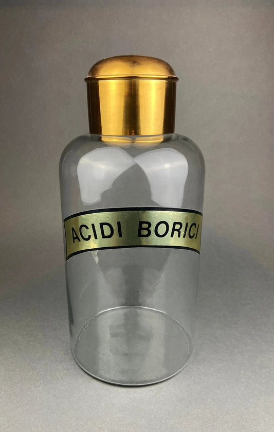 Vintage apothecary bottle with brass cap, clear glass and Acidi Borici label on Tampa Home & Garden Store