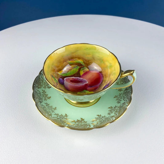 Vintage mint green tea cup and saucer set with gold trim and colorful interior motif on Tampa Home & Garden Store