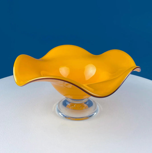 Vintage orange glass footed fruit bowl with a clear pedestal on Tampa Home & Garden Store