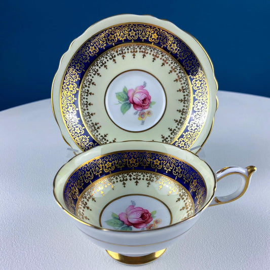 Vintage Paragon tea cup and saucer set with blue and gold ornate rim and rose center on Tampa Home & Garden Store