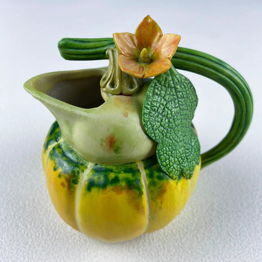 Vintage porcelain pumpkin creamer by Anything Discovered with floral bloom and green leaves on Tampa Home & Garden Store