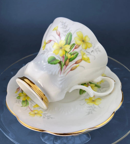 Royal Albert Primrose Tea Cup & Saucer, white bone china with yellow floral and gold rim on Tampa Home & Garden Store