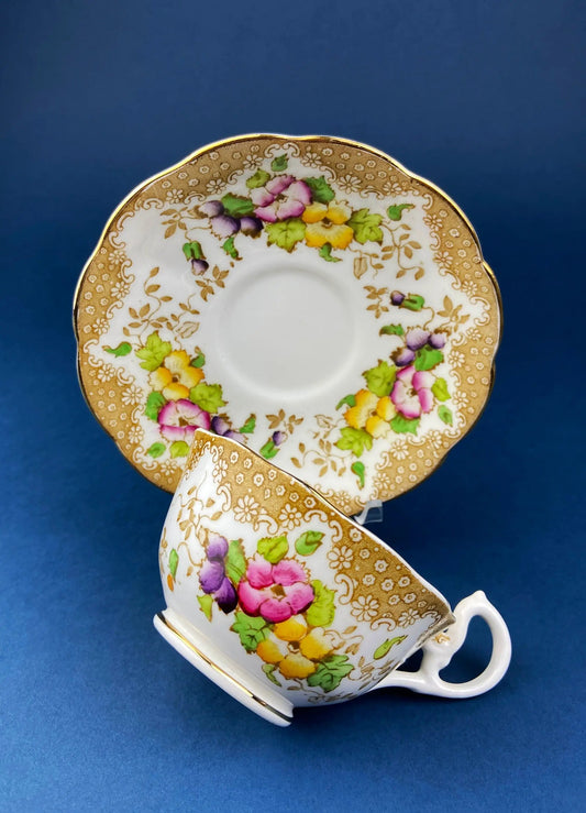Vintage Royal Albert tea cup and saucer with gold filigree and colorful floral border on Tampa Home & Garden Store