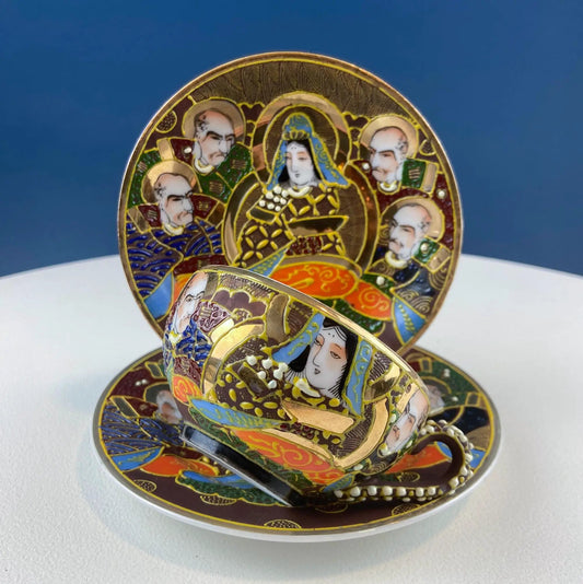 Vintage Satsuma Moriage tea set plates with gold trim and colorful portrait panels, stacked on Tampa Home & Garden Store