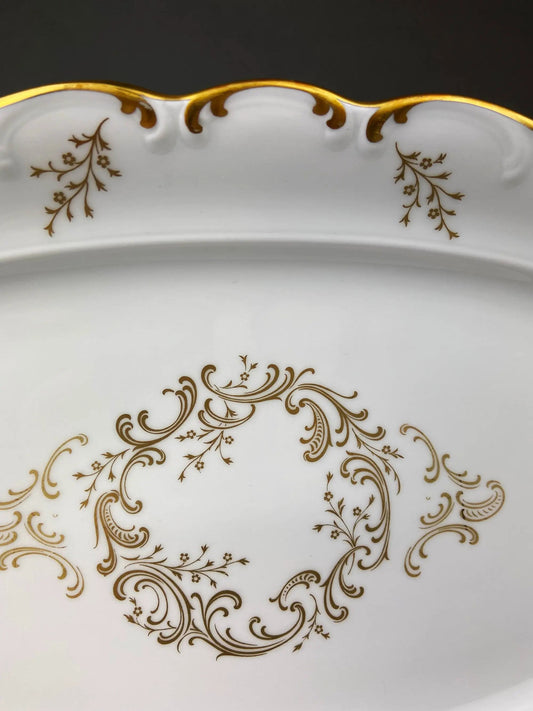 Vintage porcelain serving platter with gold rim, scalloped edge and ornate gold floral scrolls on Tampa Home & Garden Store