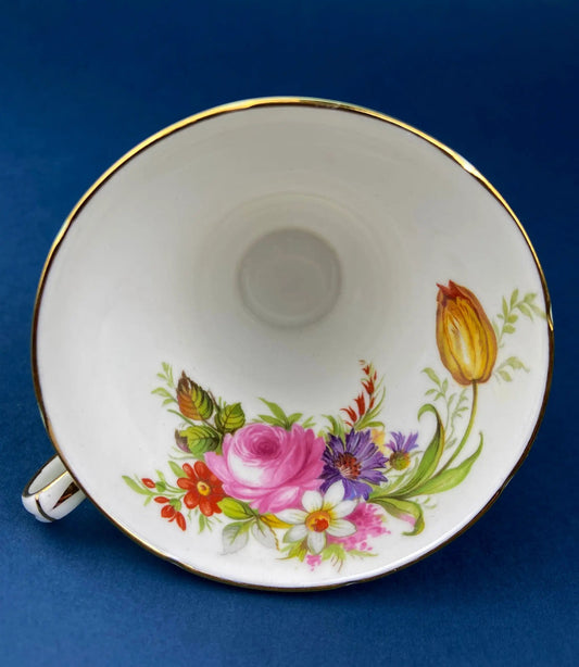 Vintage tea cup and saucer with bright floral bouquet and gold rim on white porcelain on Tampa Home & Garden Store