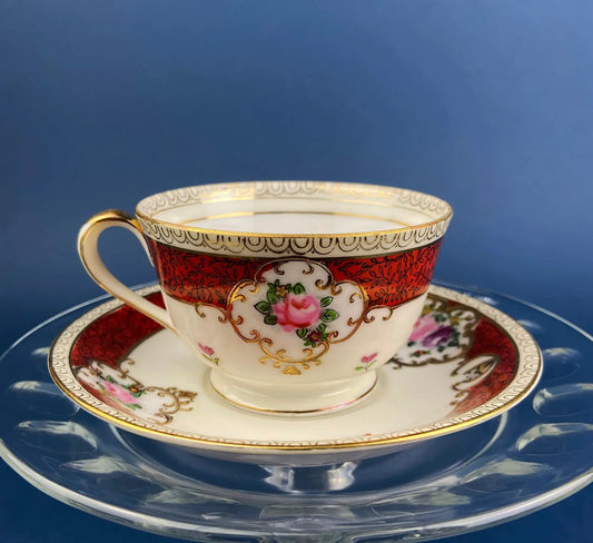 Vintage teacup and saucer; red patterned exterior with gold trim and pink rose accents on bone china on Tampa Home & Garden Store
