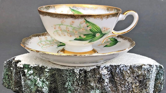 Vintage teacup and saucer white porcelain with lilies of the valley pattern and gold trim on Tampa Home & Garden Store