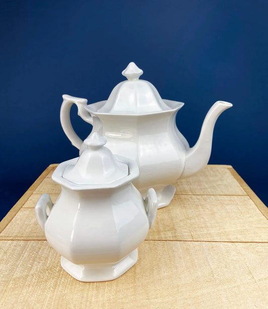 Vintage white porcelain teapot with two sugar bowls on a wooden table on Tampa Home & Garden Store
