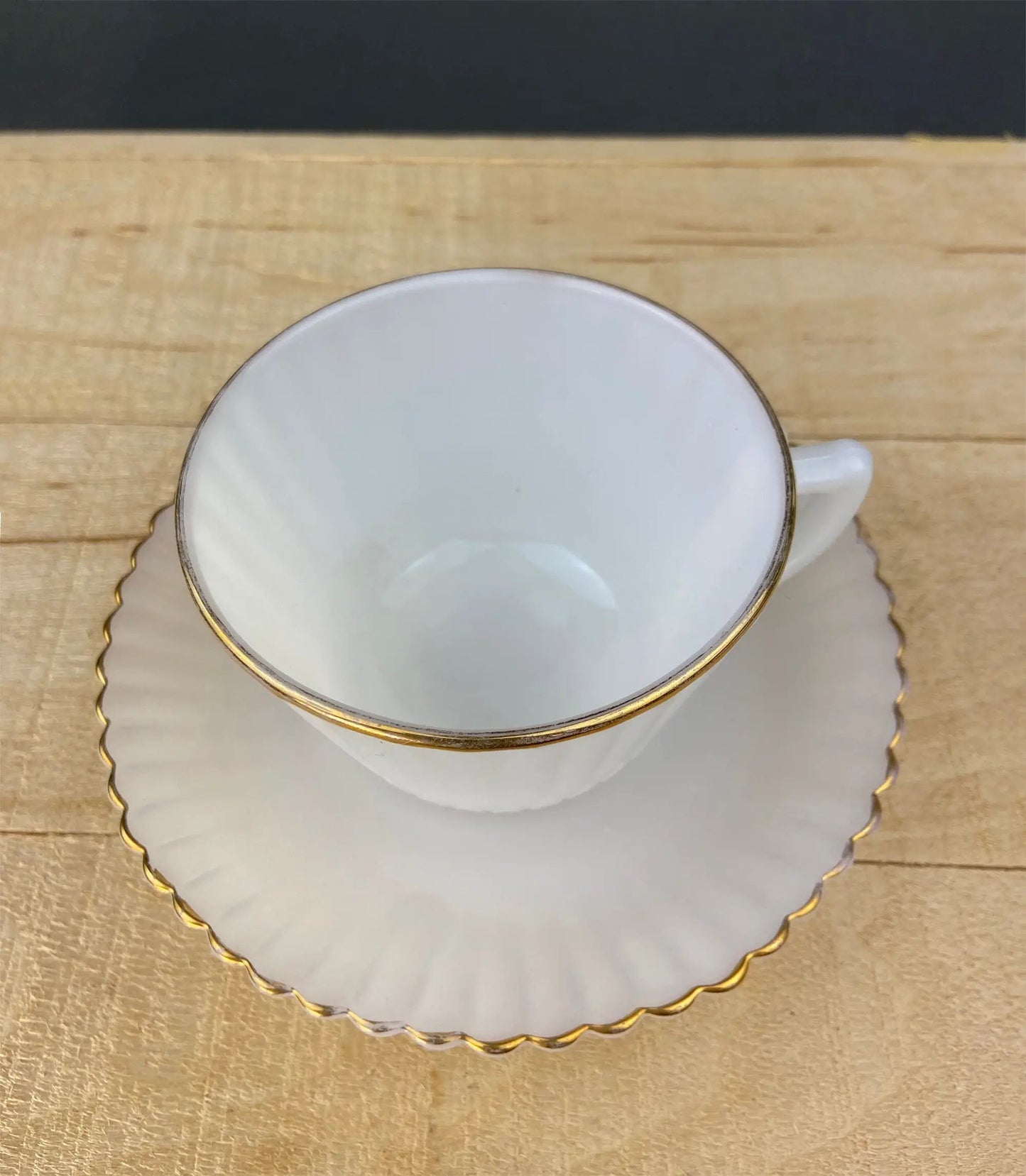 Opalescent Petalware teacup and saucer white with gold rim on wooden table on Tampa Home & Garden Store